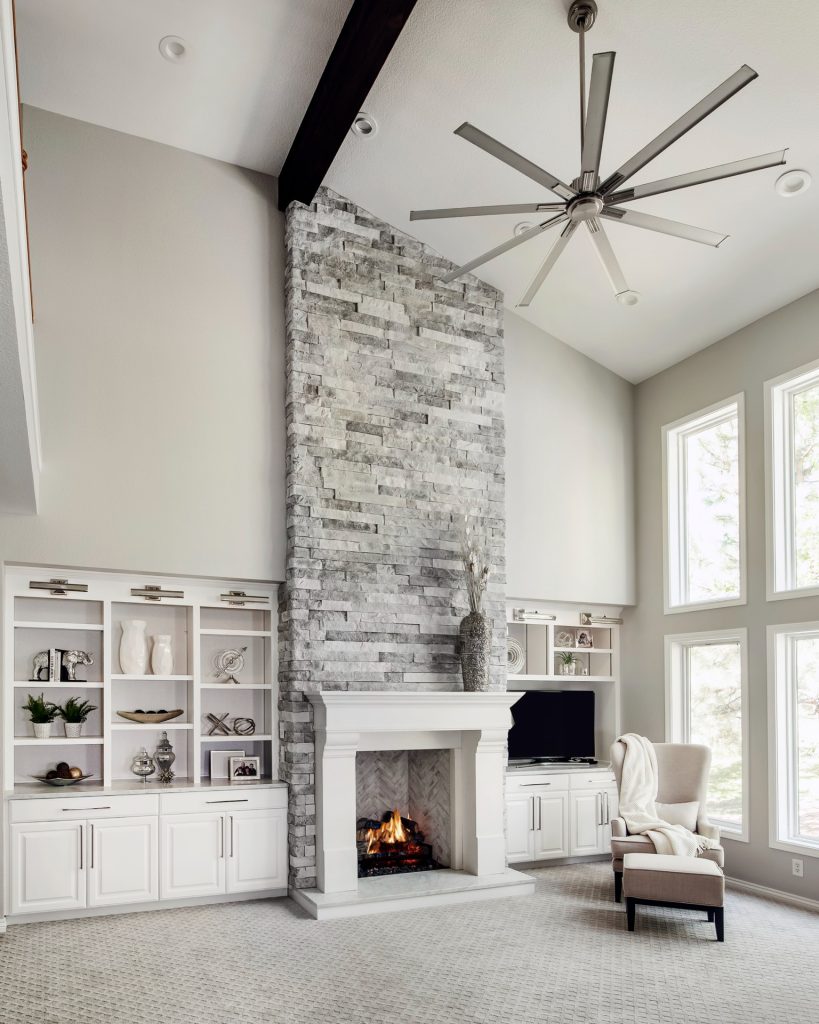 Elegant family room with high vaulted ceilings and glamorous decor, designed by Denver Design Group in Castle Pines.