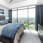 Cozy bedroom with custom blackout shades and curtains, providing privacy and a restful atmosphere.