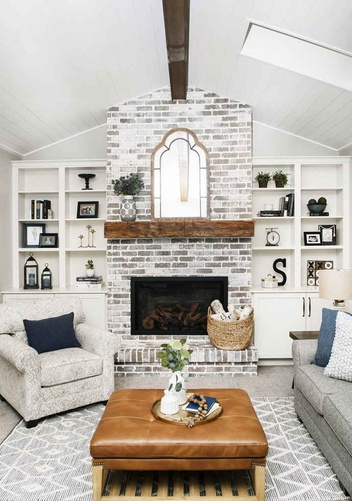 Open great-room with vaulted ceilings and fireplace in a family-friendly modern farmhouse, designed by Denver Design Group for comfortable family living.