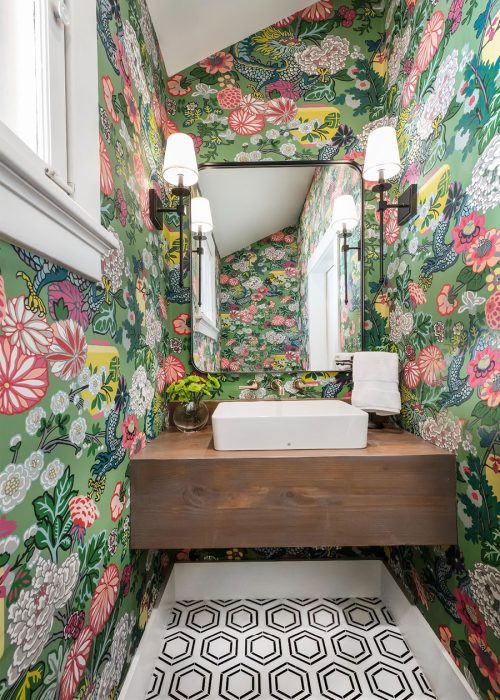 Bright bathroom with bold wallpaper, floating farmhouse sink, and monochrome tile, designed by Denver Design Group in a remodeled historic Wash Park bungalow.