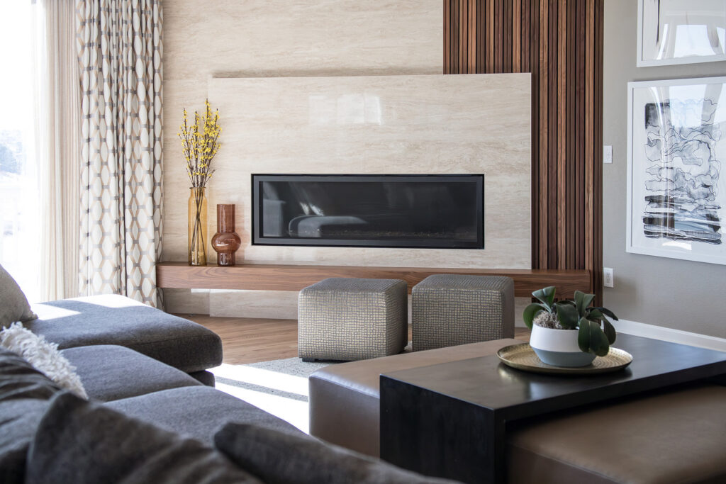 Modern fireplace with tambour walls and large porcelain tiles in a contemporary family room remodel in Aurora Colorado by Denver Design Group