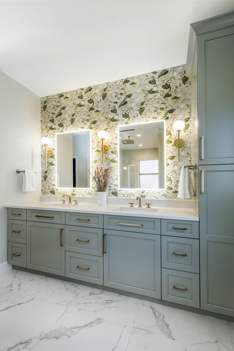 Colored cabinetry and bold wallpapers with color and pattern, creating a welcoming and timeless look for an Englewood and Ken Caryl remodel interior design project by Denver Design Group.