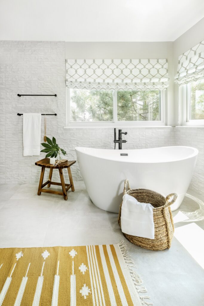 Primary bathroom remodel in Lone Tree by Denver Design Group with Mosaico Nantes Caliza wall tile by Porcelanosa, showcasing 2025 design trends including textured wall details and artistic design.