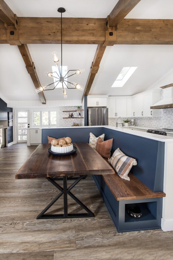 Contemporary kitchen remodel open concept with exposed beams and functional storage solutions including a breakfast nook with custom built in bench and additional storage