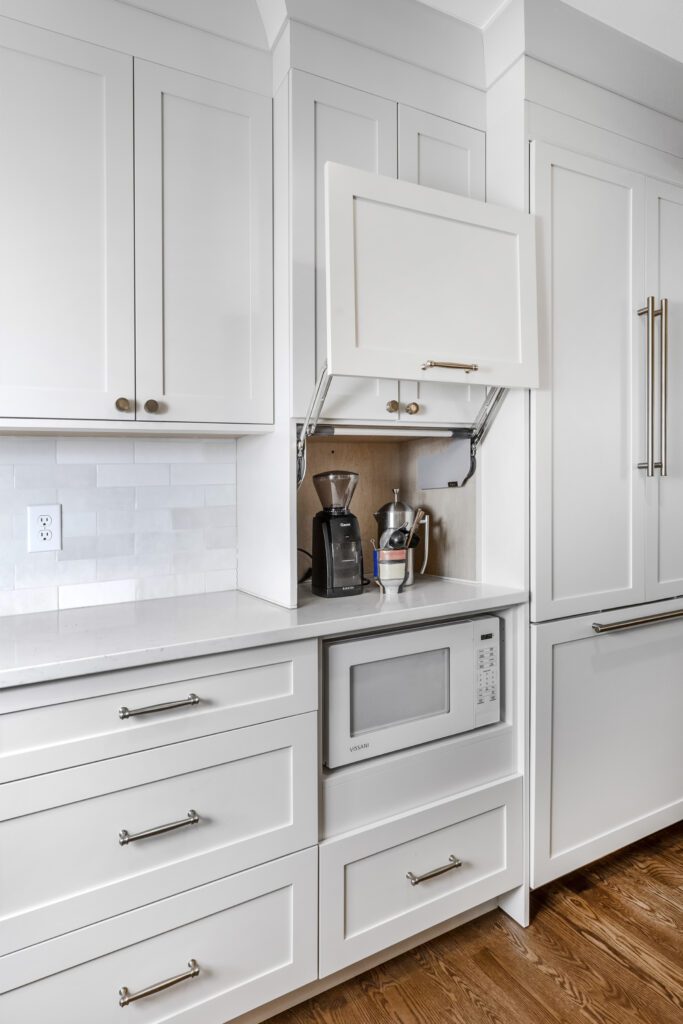 Denver Design Group custom kitchen remodel with functional storage solutions like appliance garages for a sleek and modern kitchen design.