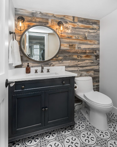 Denver Design Group Littleton remodel of a powder bathroom of a modern farmhouse with patterned tile and reclaimed wood accent wall