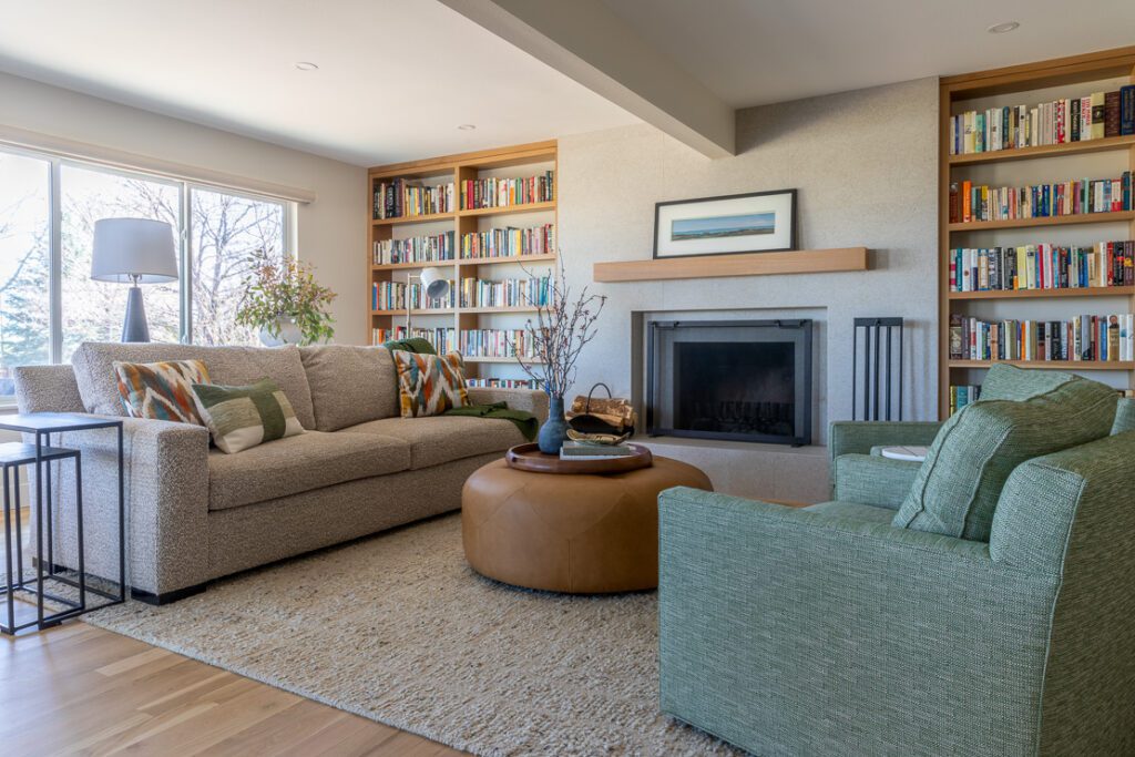 Functional family room featuring warm textures, curated lighting, and integrated shelving in Littleton home remodel by Denver Design Group