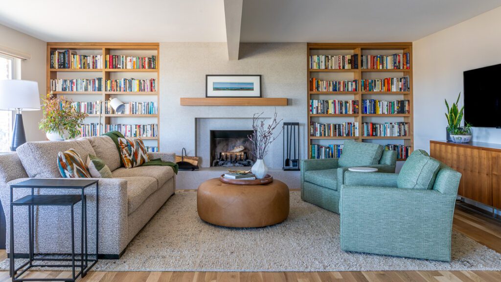 Main living area with updated fireplace, built-in shelving, and Scandinavian-inspired contemporary design by Denver Design Group for a Littleton home remodel