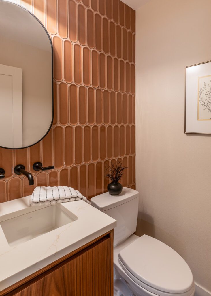 Powder room remodel with custom vanity, brass fixtures, and minimalist tile by Denver Design Group in Littleton remodel