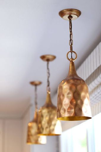 Statement lighting fixtures that blend timeless design with modern style in a thoughtfully curated interior by Denver Design Group