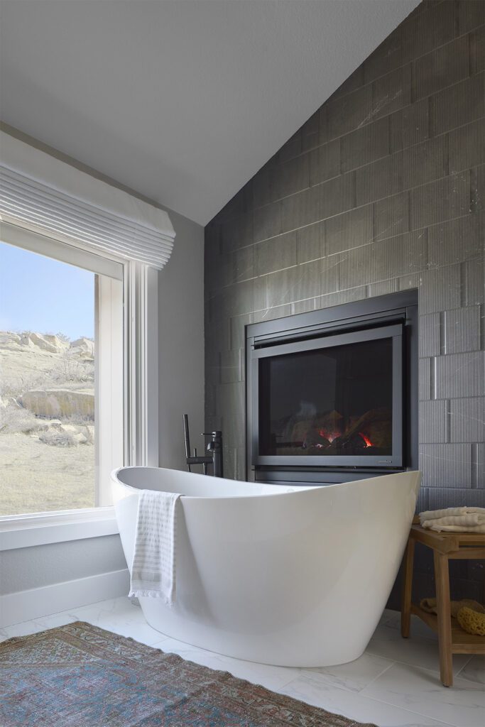 Primary suite bathroom remodel in Littleton with freestanding tub and fireplace focal point