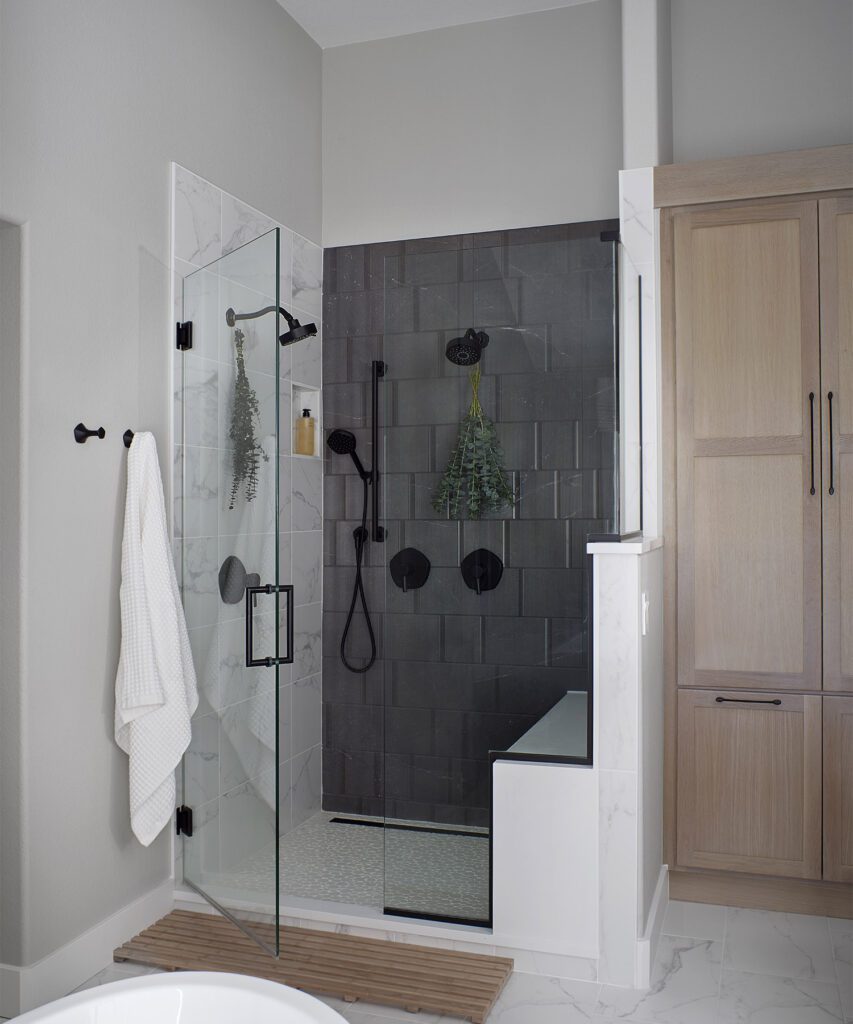Custom bathroom remodel in Littleton featuring layered storage, walk-in shower, and spa-like design