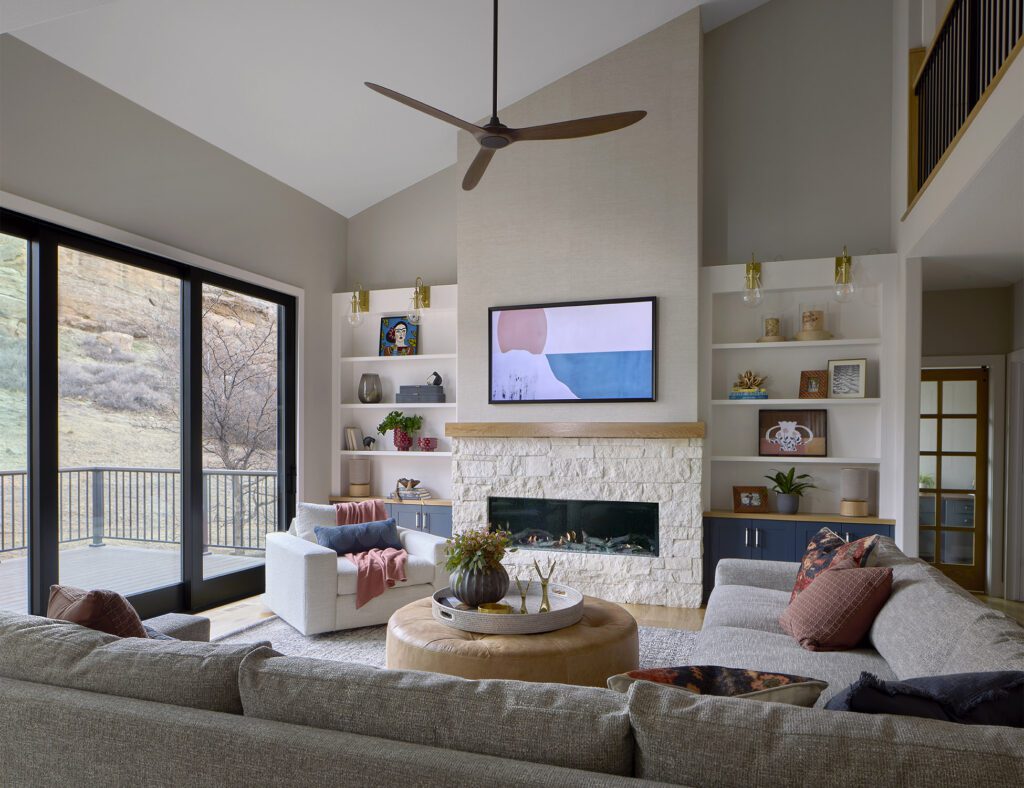 Open concept living room remodel with fireplace and smart storage and shelving solutions, custom cabinetry and curated furnishings