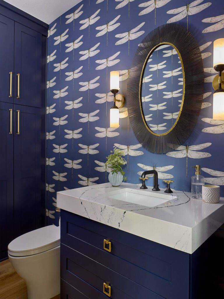 Custom powder room with statement wallpaper and smart storage solutions in Littleton home remodel