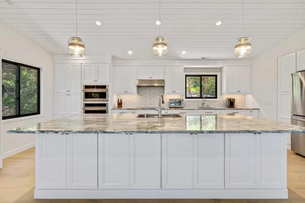 Castle Rock kitchen remodel by Denver Design Group with large quartzite island and seating for six