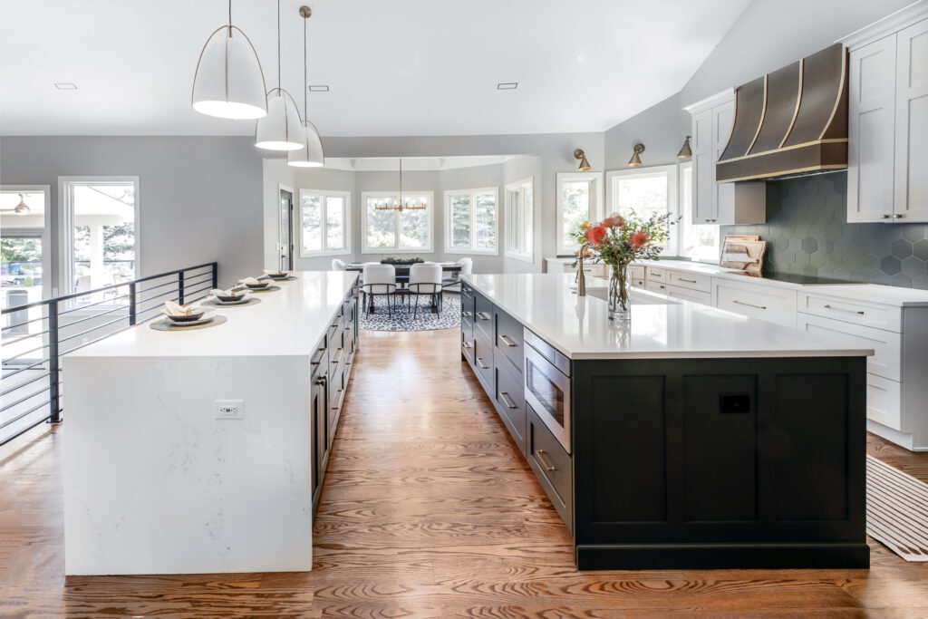 Littleton kitchen remodel of 1980s Parade of Homes by Denver Design Group with double islands for prep space and entertaining