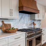 Modern kitchen remodel in Denver featuring forest green custom hutch and soapstone countertop and luxury appliances