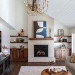 Remodeled family room with plaster fireplace, custom built-ins, and open sightlines showcasing cohesive main floor connection