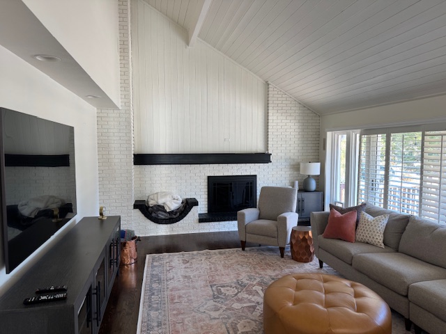 Original 1990s Colorado family room before plaster fireplace redesign, lacking visual connection to kitchen and dining areas