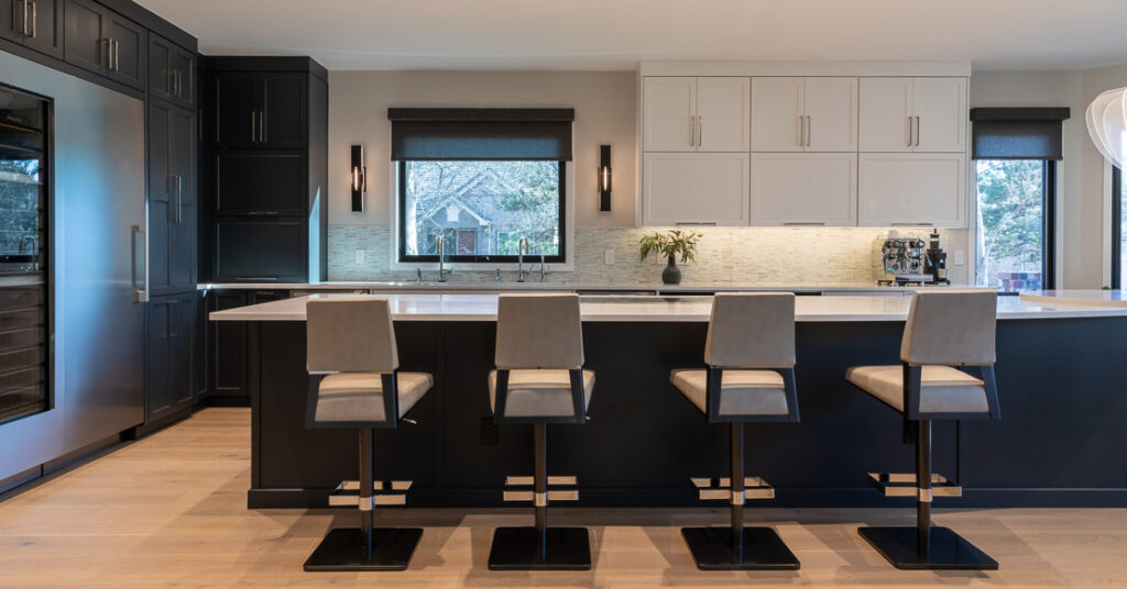 Contemporary kitchen island with built-in wine fridge and clean-lined cabinetry in Greenwood Village home