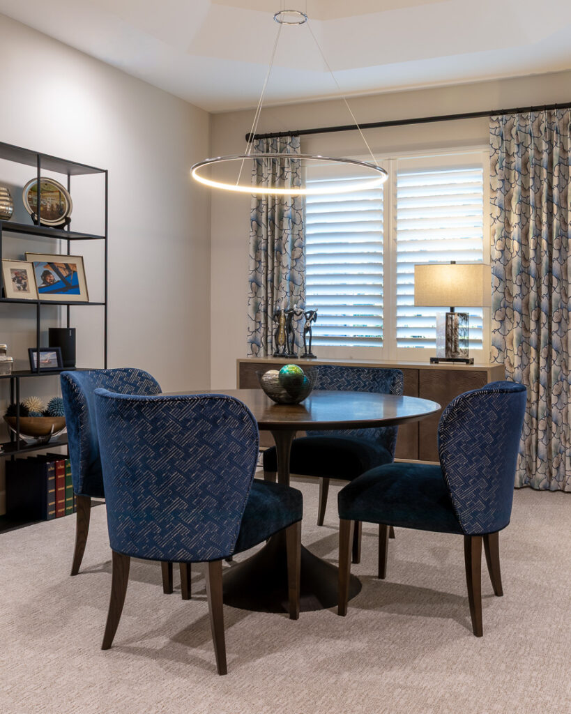 Formal dining room converted into game room for empty nesters with reupholstered dining chairs in Greenwood Village home remodel