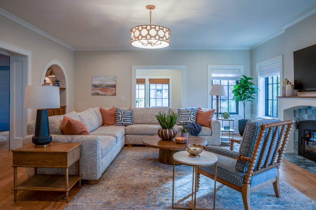 Family room with custom furnishings, arch bookcases, and fireplace in Park Hill Denver whole home remodel by Denver Design Group