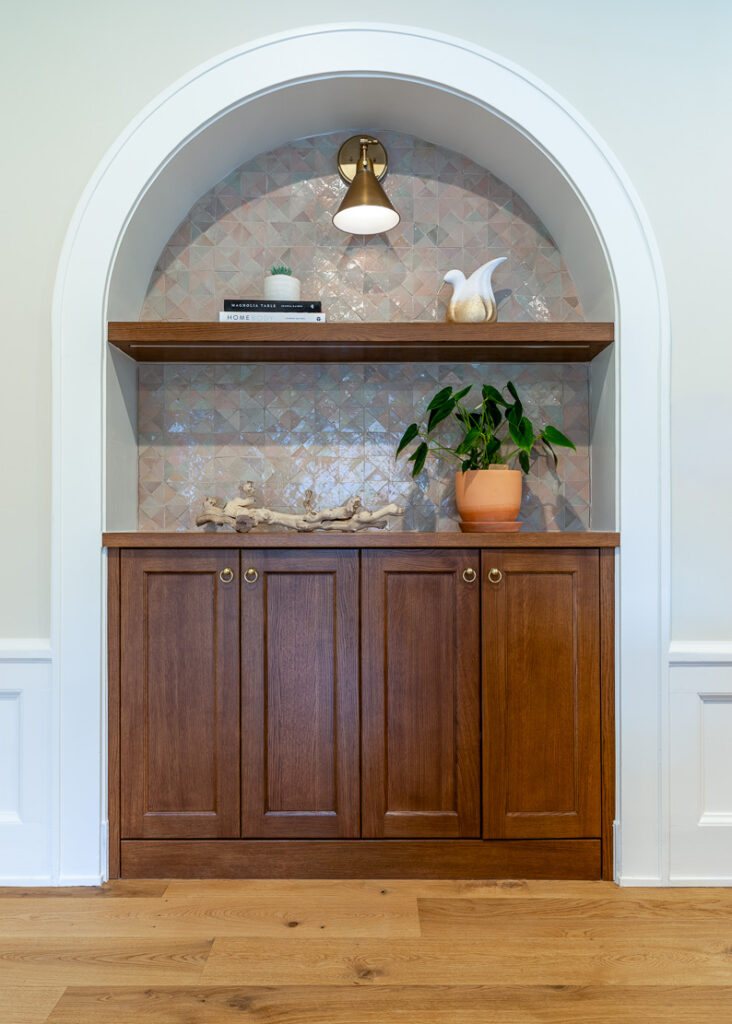 Arch niche with terracotta tile and walnut built-in cabinetry in Park Hill Denver Spanish Colonial remodel