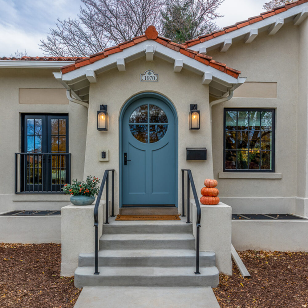 Park Hill Denver Spanish Colonial Revival Remodel blue front door stucco exterior terracotta roof tiles by Denver Design Group