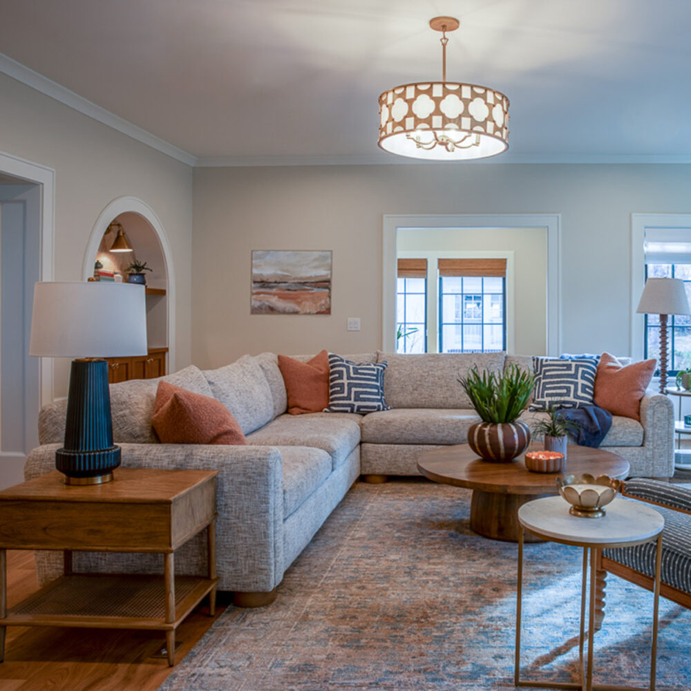 Family room with custom furnishings, arch bookcases, and fireplace in Park Hill Denver whole home remodel by Denver Design Group