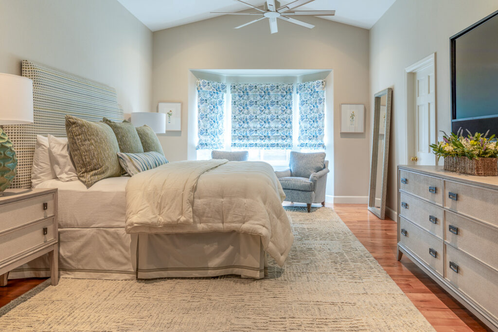 Primary bedroom with custom Massoud headboard and layered bedding Lone Tree Colorado Denver Design Group