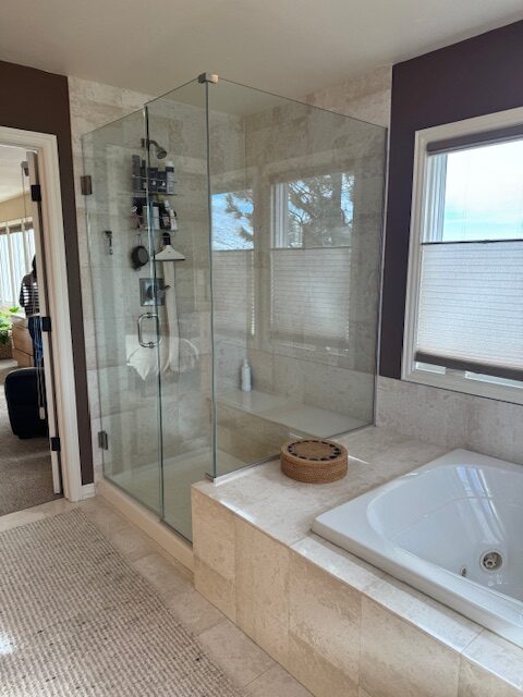 Before photo of dated primary bathroom with heavy vanity and builder-grade tile Littleton Colorado