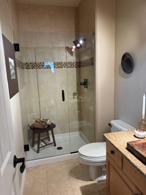 Before photo of outdated three quarter bathroom with honey oak vanity and copper vessel sink Littleton Colorado